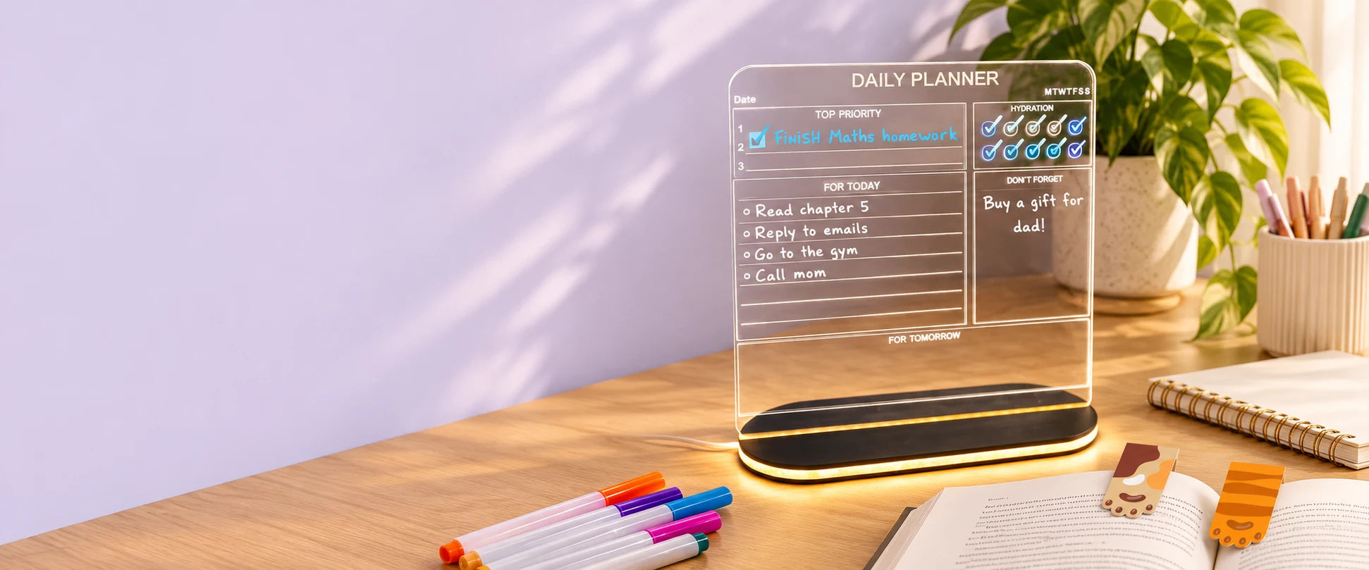 LED writing board, markers and magnetic bookmarks on a creative desk